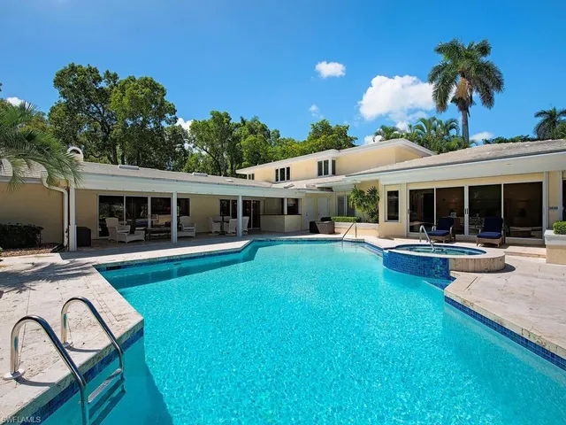 a view of a house with swimming pool and a chairs