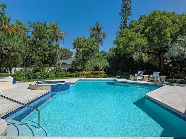 a view of a swimming pool with lounge chair