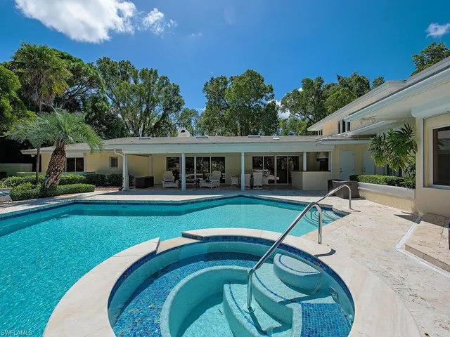 a swimming pool with outdoor seating and yard