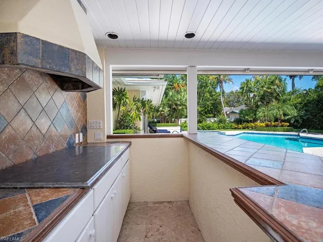 a kitchen with kitchen island a large window in it