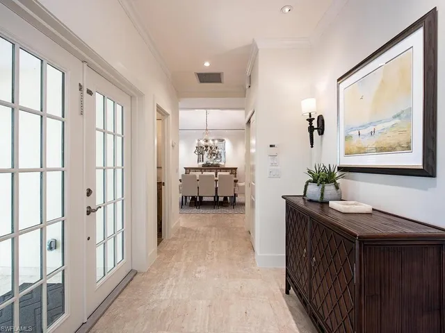 a view of a hallway with bathroom and wooden floor
