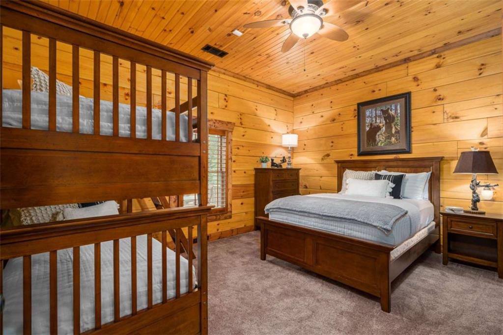 31 High Cliff Road Jasper, GA 30143 - Photo 23 of 50 a spacious bedroom with a bed and wooden floor