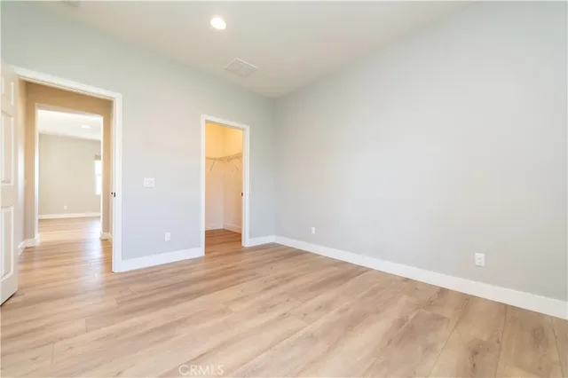 a view of an empty room and wooden floor
