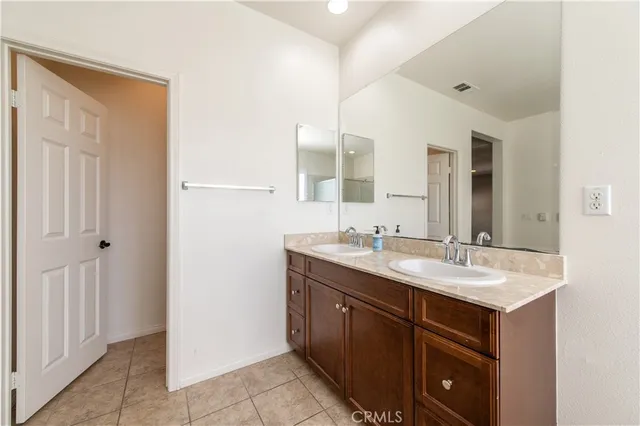 a bathroom with a double vanity sink and mirror