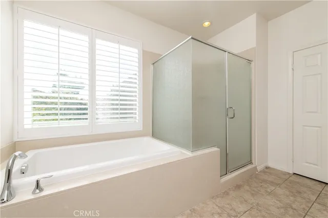 a bathroom with a bathtub and a shower