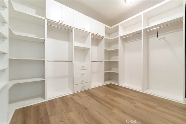 a view of walk in closet with empty racks