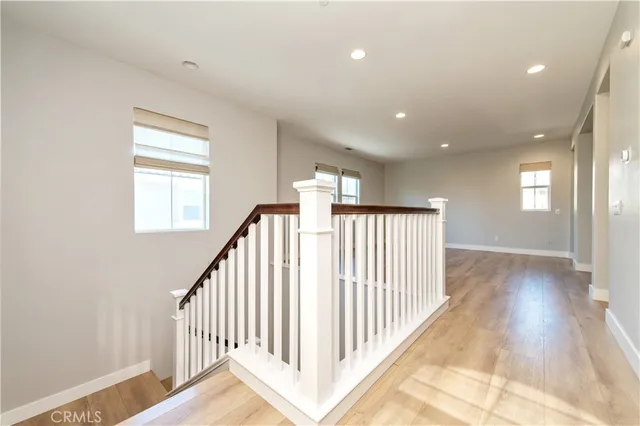 a view of a hallway with a window and stairs