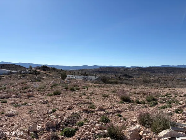 a view of a large mountain with a mountain in the background