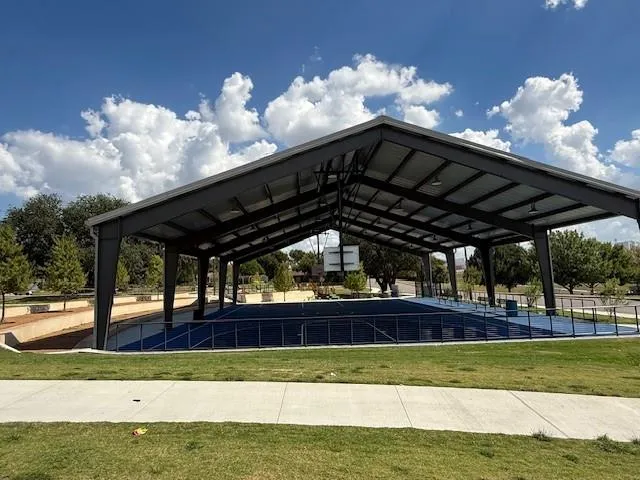 a view of a building with snow on the road