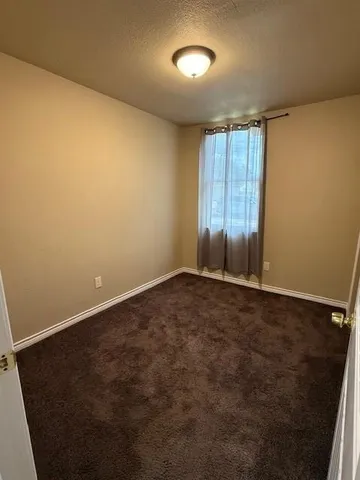 an empty room with a empty space and windows