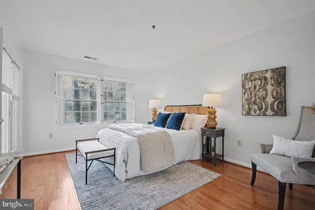 a bed room with a bed and a chair