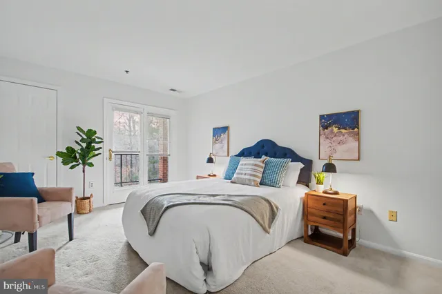 a bedroom with a bed and a potted plant