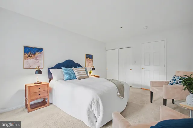 a bedroom with a bed and a couch