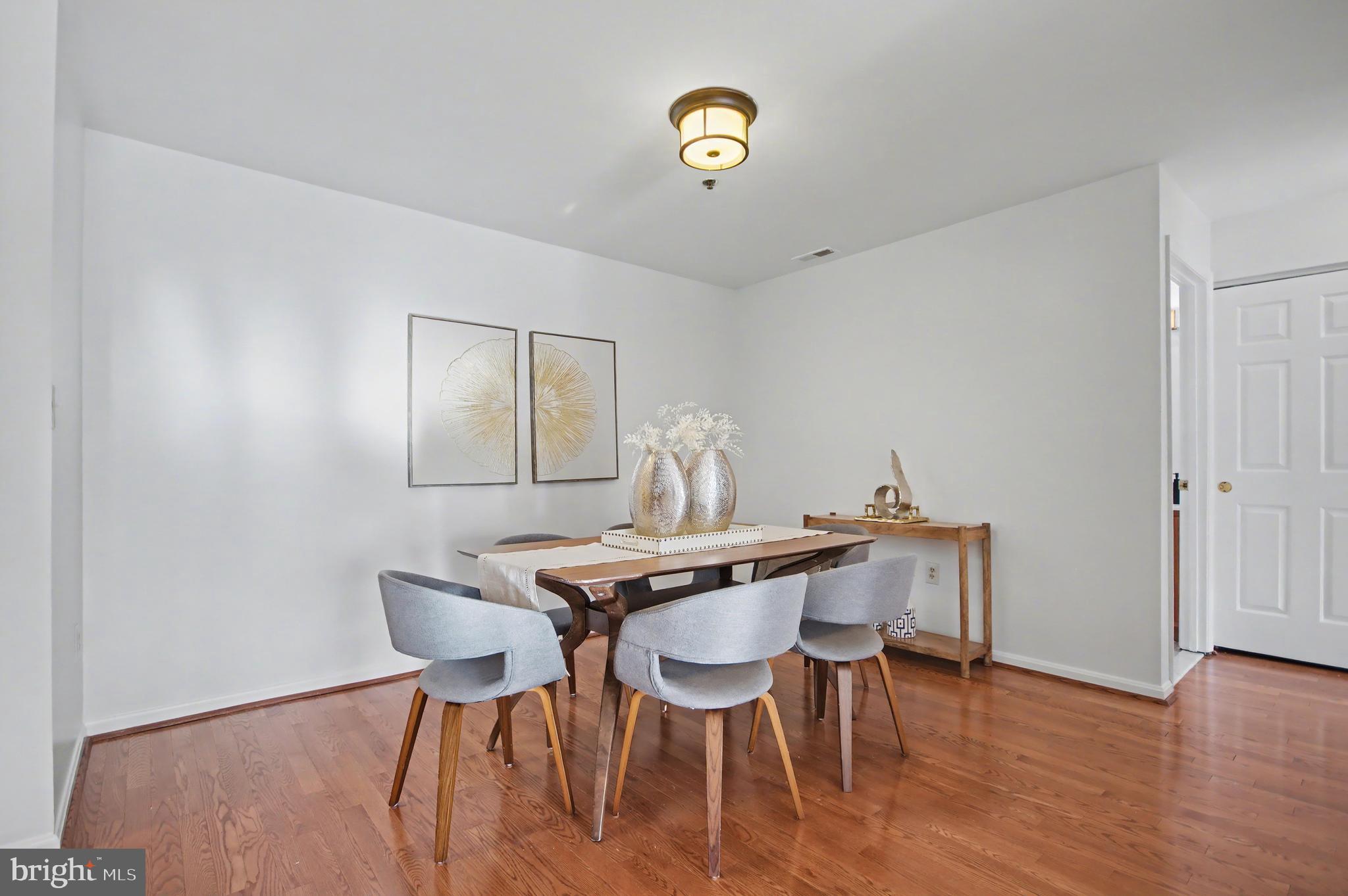 803 Coxswain Way, Unit 203 Annapolis, MD 21401 - Photo 5 of 44 a view of a dining room with furniture and wooden floor