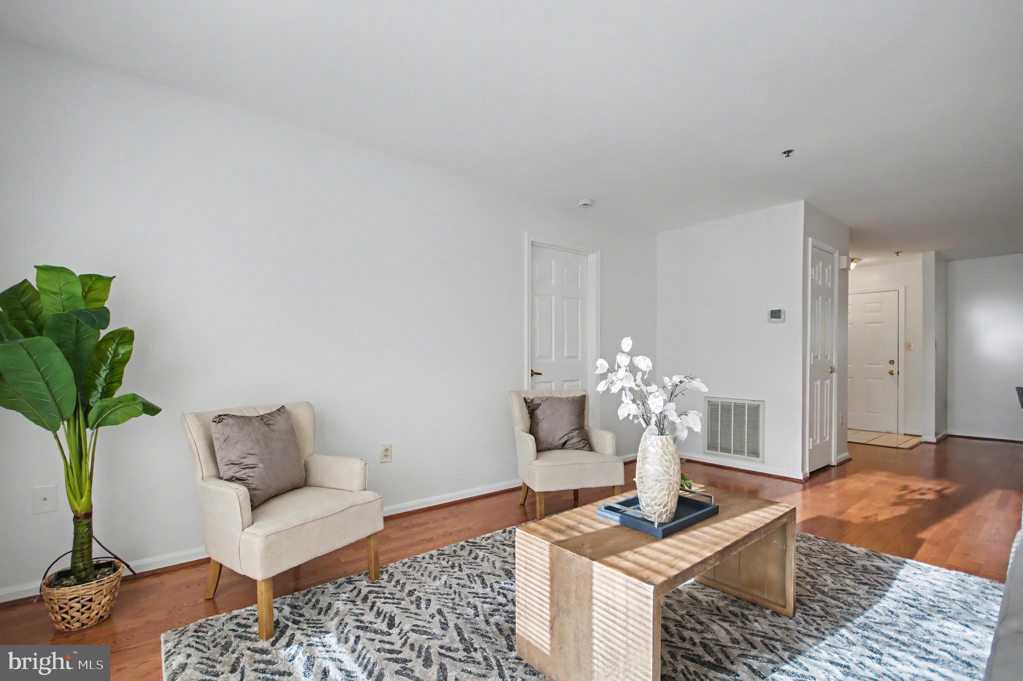 803 Coxswain Way, Unit 203 Annapolis, MD 21401 - Photo 8 of 44 a living room with furniture and a chandelier