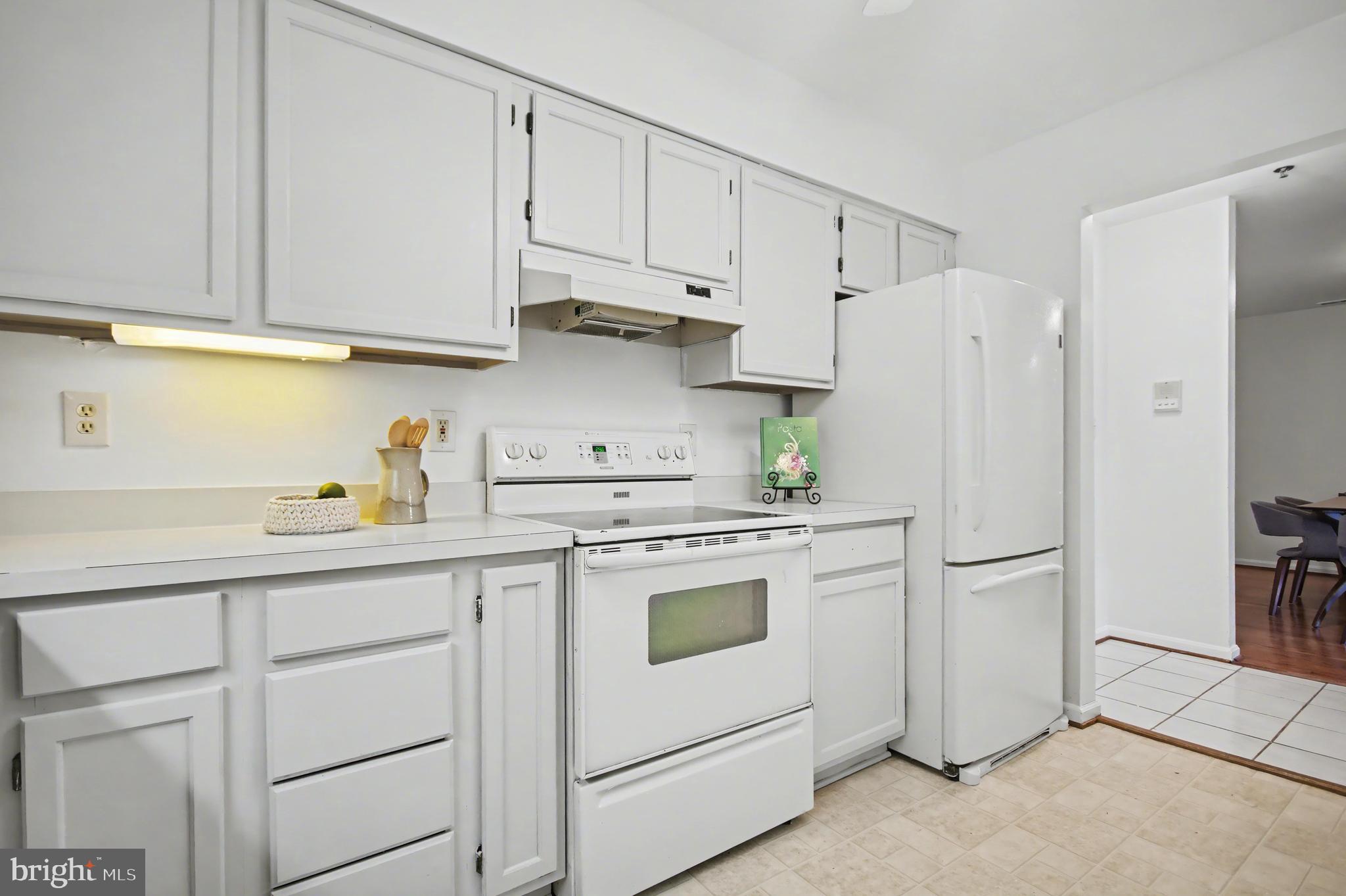 803 Coxswain Way, Unit 203 Annapolis, MD 21401 - Photo 10 of 44 a kitchen with white cabinets and white appliances