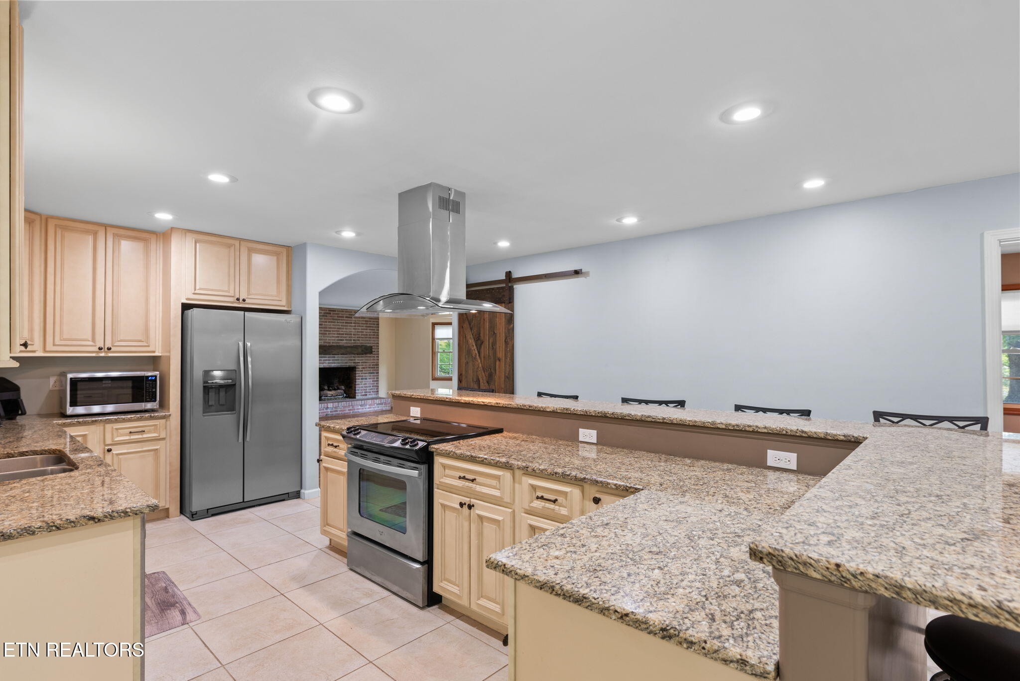 114 Canterbury Road Oak Ridge, TN 37830 - Photo 12 of 42 a kitchen with stainless steel appliances granite countertop a sink stove and refrigerator