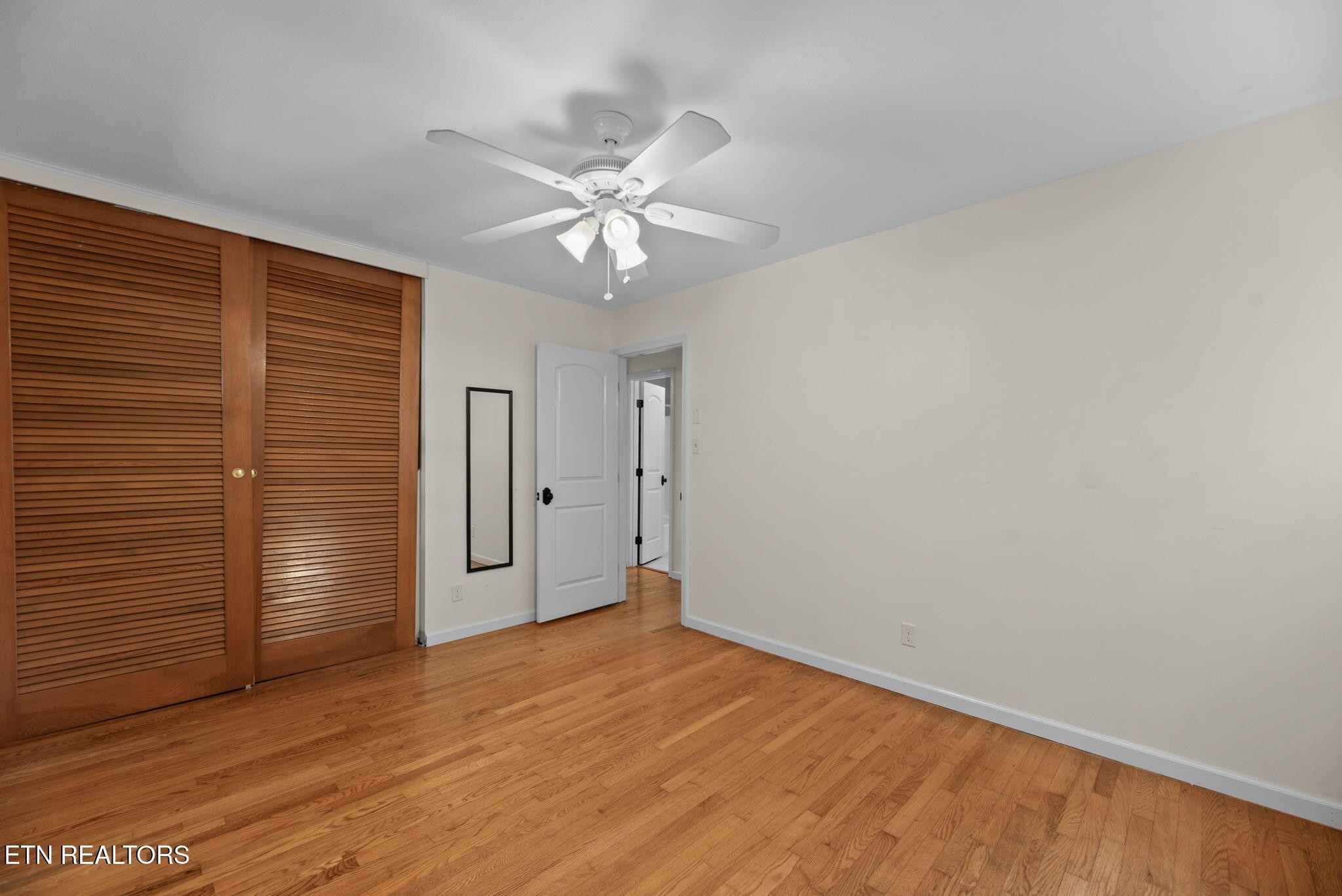 114 Canterbury Road Oak Ridge, TN 37830 - Photo 27 of 42 a view of empty room with wooden floor and fan