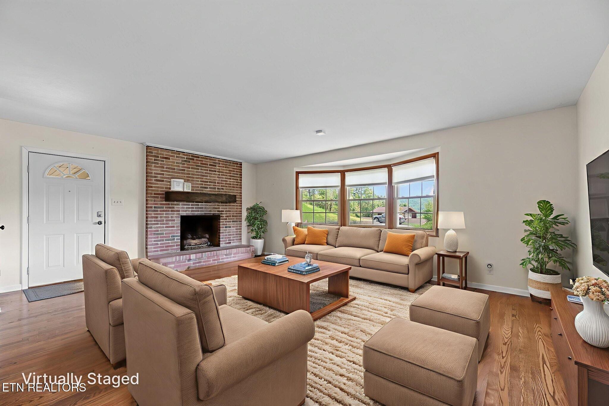 114 Canterbury Road Oak Ridge, TN 37830 - Photo 6 of 42 a living room with furniture a fireplace and a potted plant