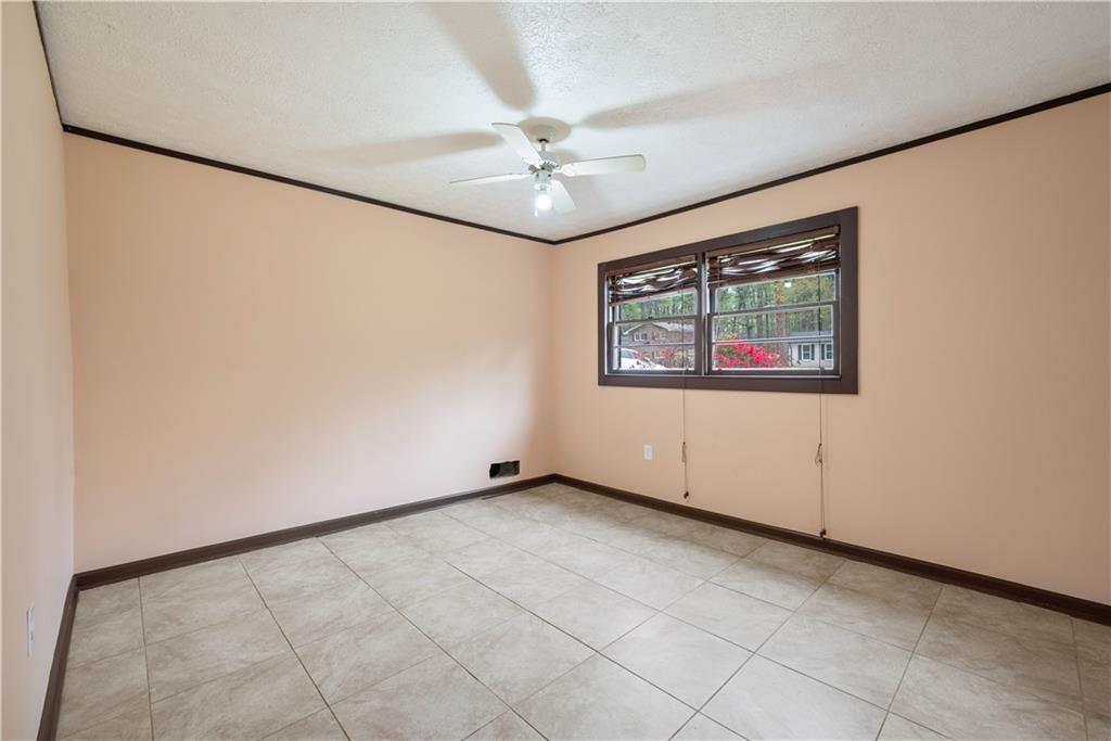 4329 Cedar Valley Lane Conley, GA 30288 - Photo 12 of 25 an empty room with a ceiling fan and a window