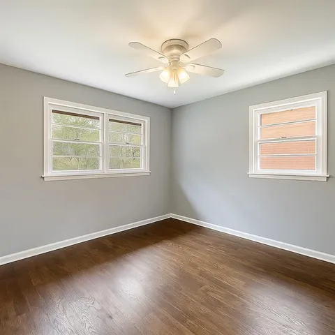a view of wooden floor and windows in a room