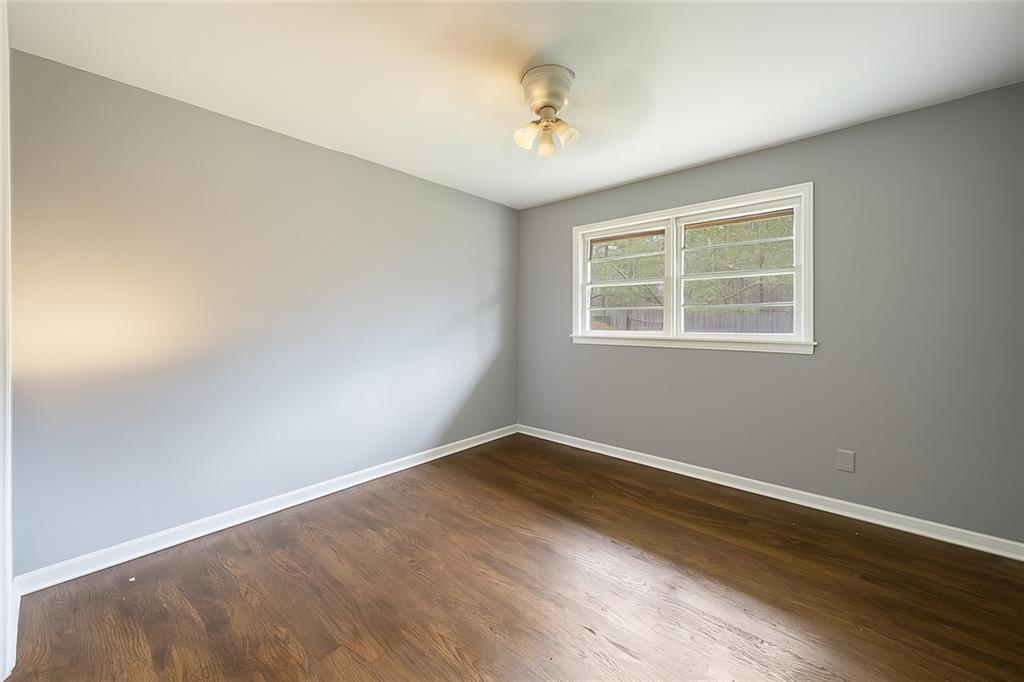 4329 Cedar Valley Lane Conley, GA 30288 - Photo 18 of 25 an empty room with wooden floor and windows