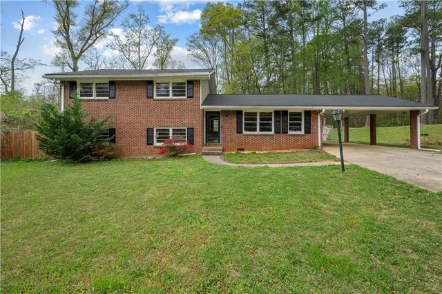 a front view of house with yard and green space