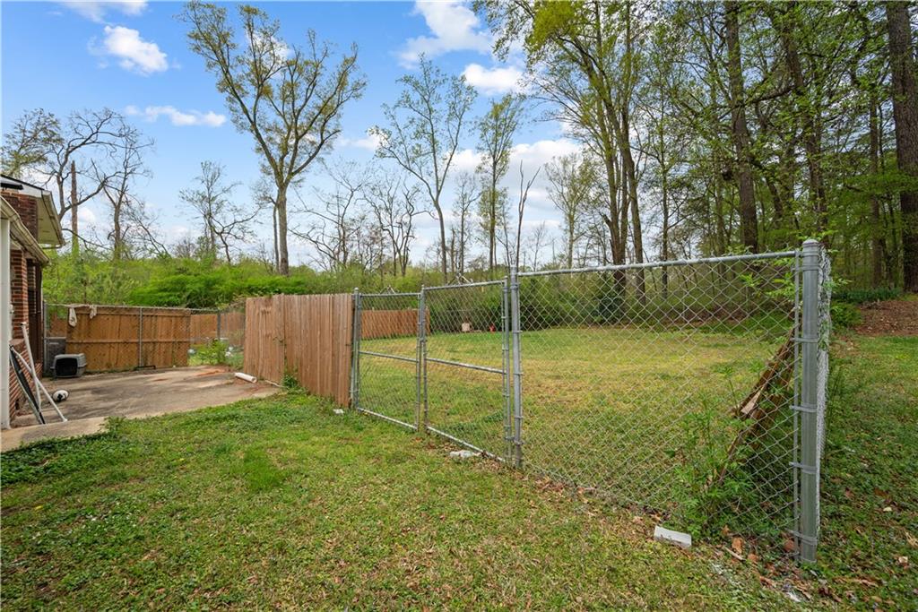 4329 Cedar Valley Lane Conley, GA 30288 - Photo 24 of 25 a view of a backyard with large trees