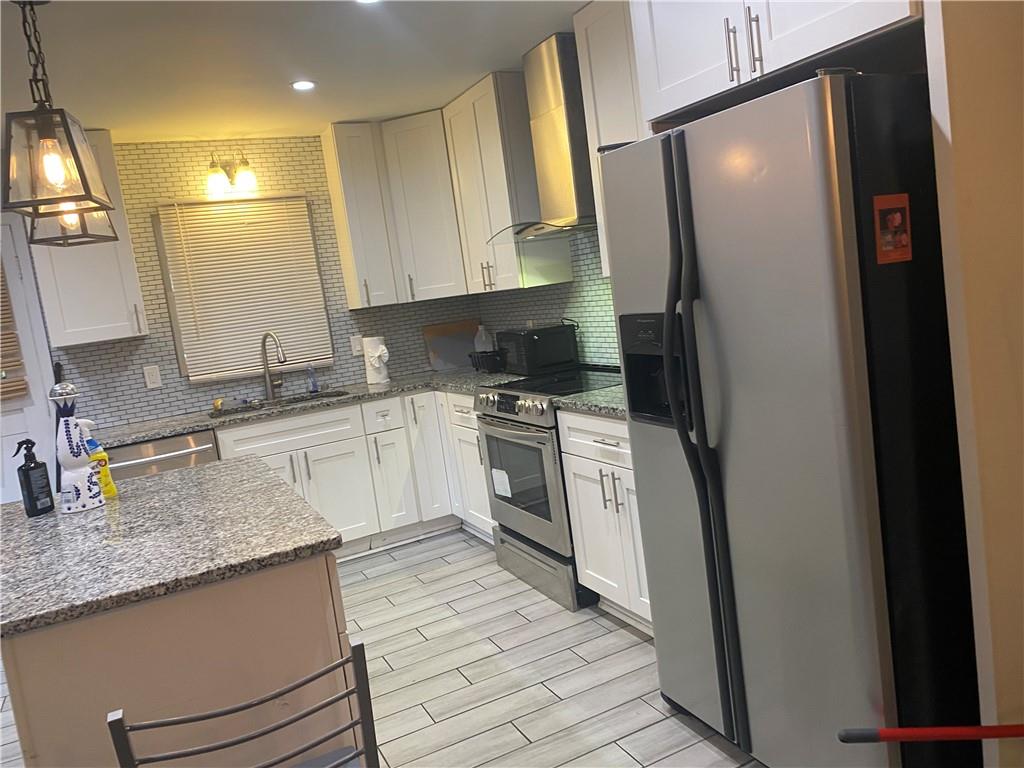 4329 Cedar Valley Lane Conley, GA 30288 - Photo 4 of 25 a kitchen with white cabinets and white appliances