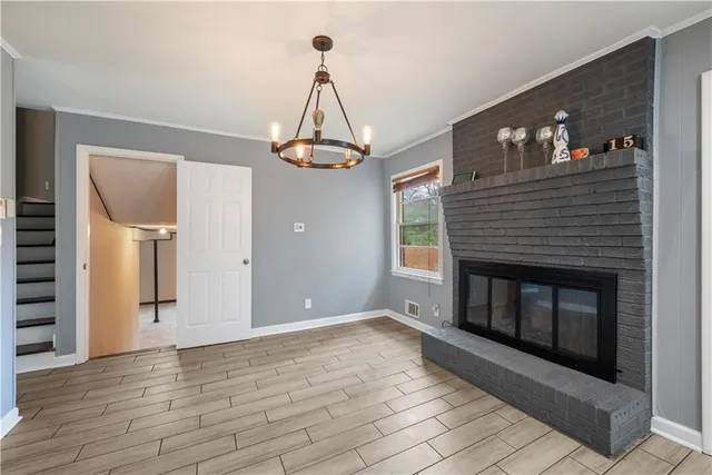 a view of a livingroom with a fireplace and wooden floor