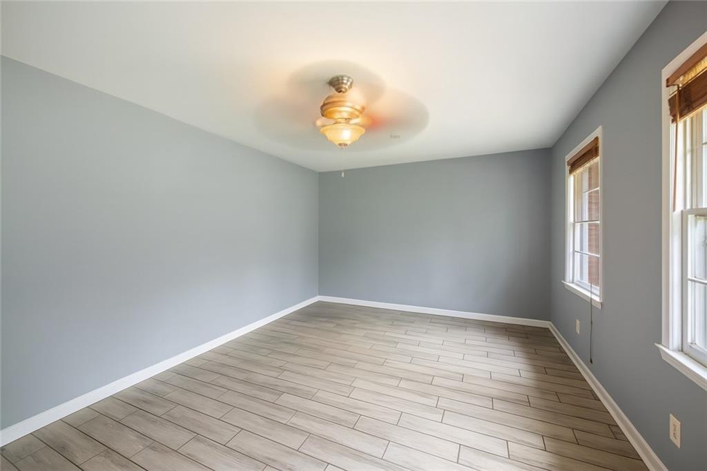 4329 Cedar Valley Lane Conley, GA 30288 - Photo 9 of 25 an empty room with wooden floor and windows