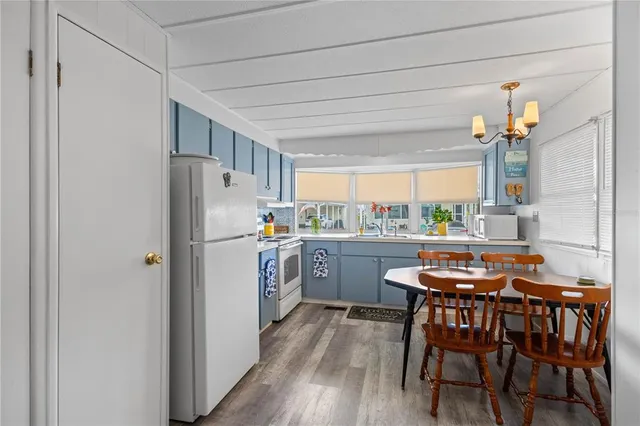 a kitchen with refrigerator a table and chairs