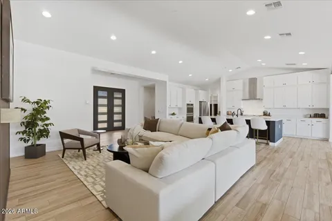 a living room with furniture or wooden floor and a potted plant