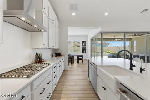 a large white kitchen with a large window