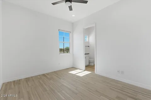 a bathroom with a granite countertop sink a mirror and a bathtub
