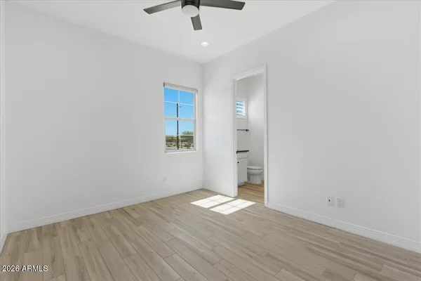 a bathroom with a granite countertop sink a mirror and a bathtub