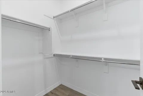 a bedroom with furniture and a large window