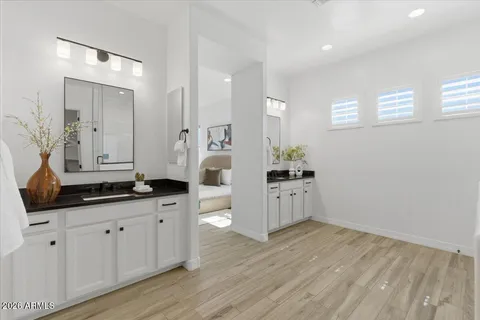 a bathroom with granite countertop a sink and a mirror