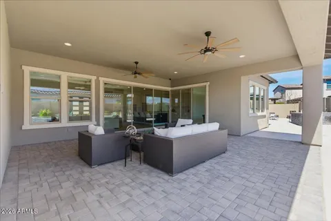 a living room with fireplace furniture and a large window