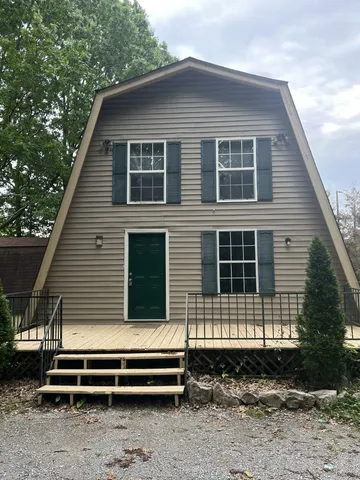 a front view of a house with a car