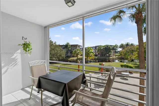 a view of a porch with furniture and wooden floor