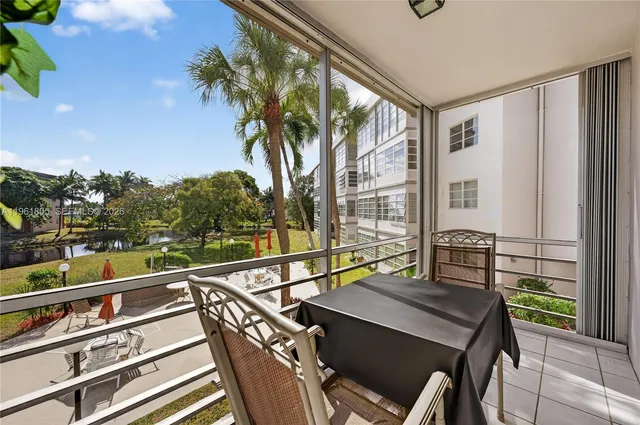 a view of a balcony with two chairs and a table