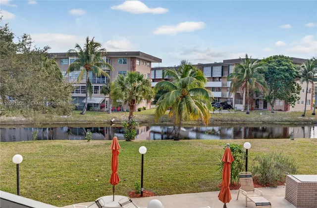 a front view of house with a garden