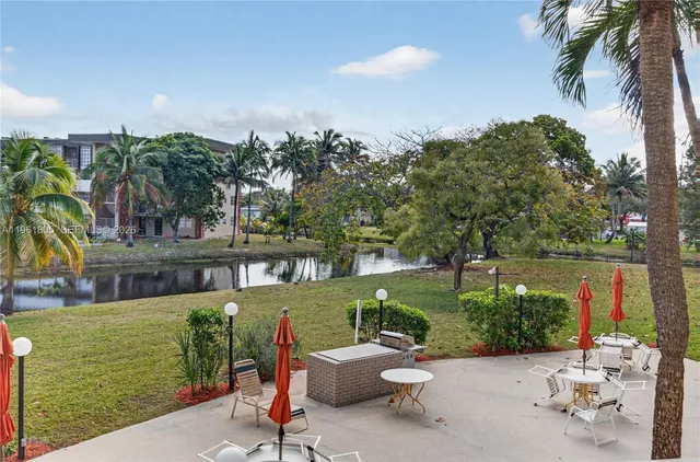 a view of a chairs and table in patio with a lake view