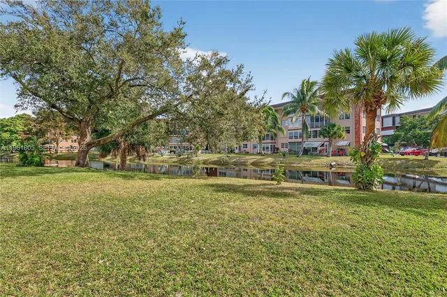 a swimming pool with outdoor seating and yard