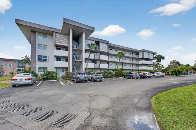 a view of a street with a cars parked in front of it