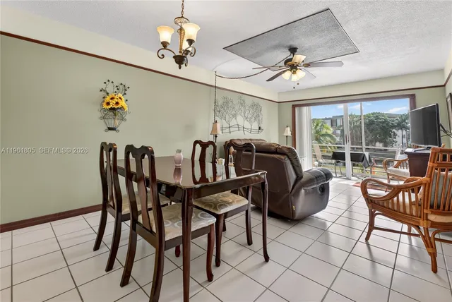 a view of a dining room with furniture chandelier and a chandelier
