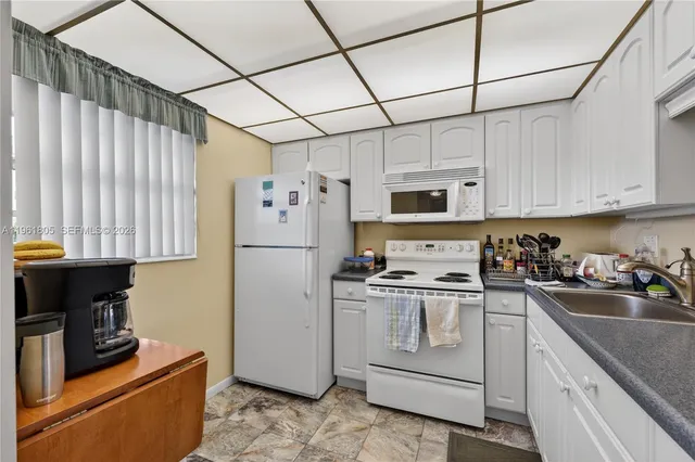 a kitchen with stainless steel appliances a refrigerator sink and cabinets