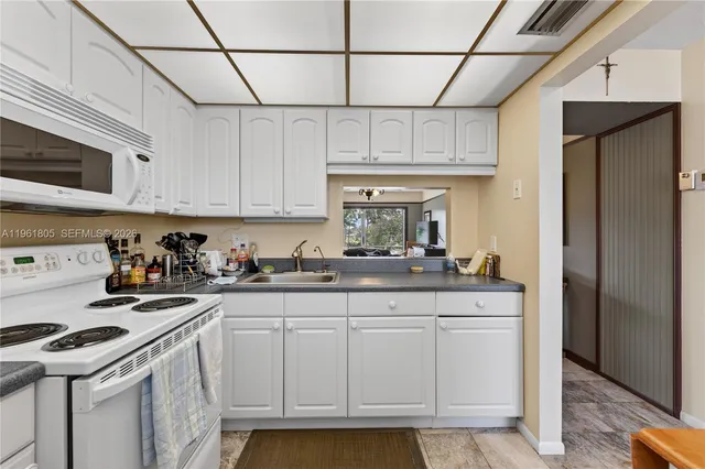 a kitchen with stainless steel appliances granite countertop a sink and cabinets