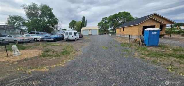 a view of a house with backyard and sitting area